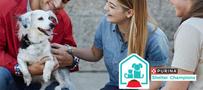 three people with black and white dog, Purina Shelter Champions logo